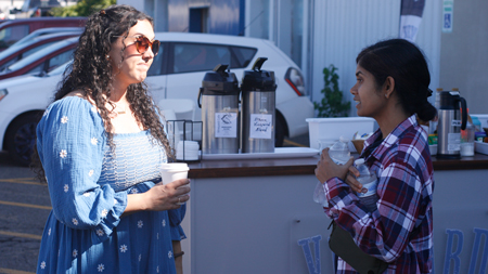 Two women chatting outside Vineyard Church of Ithaca