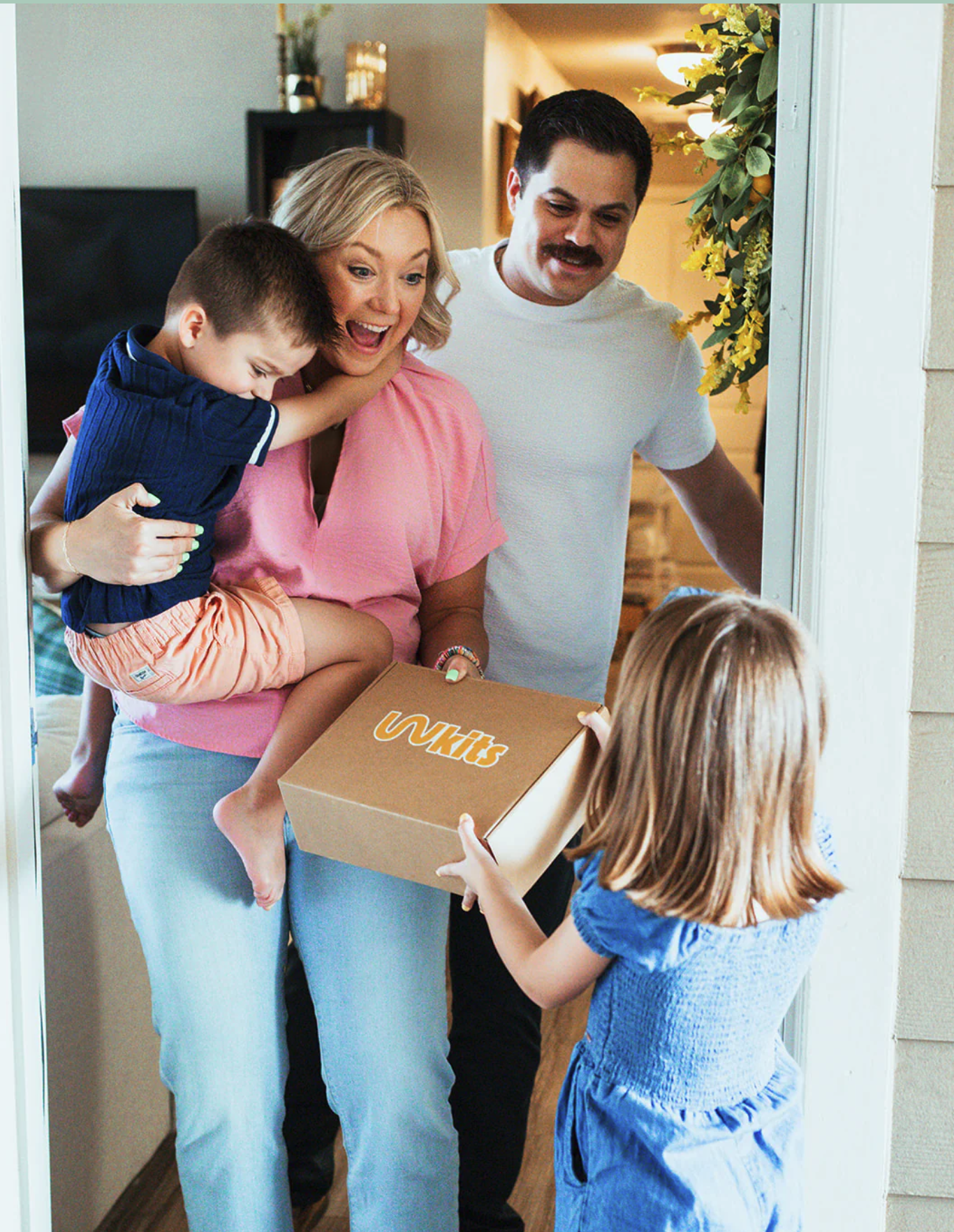 Family receiving a WITH Kit at the door
