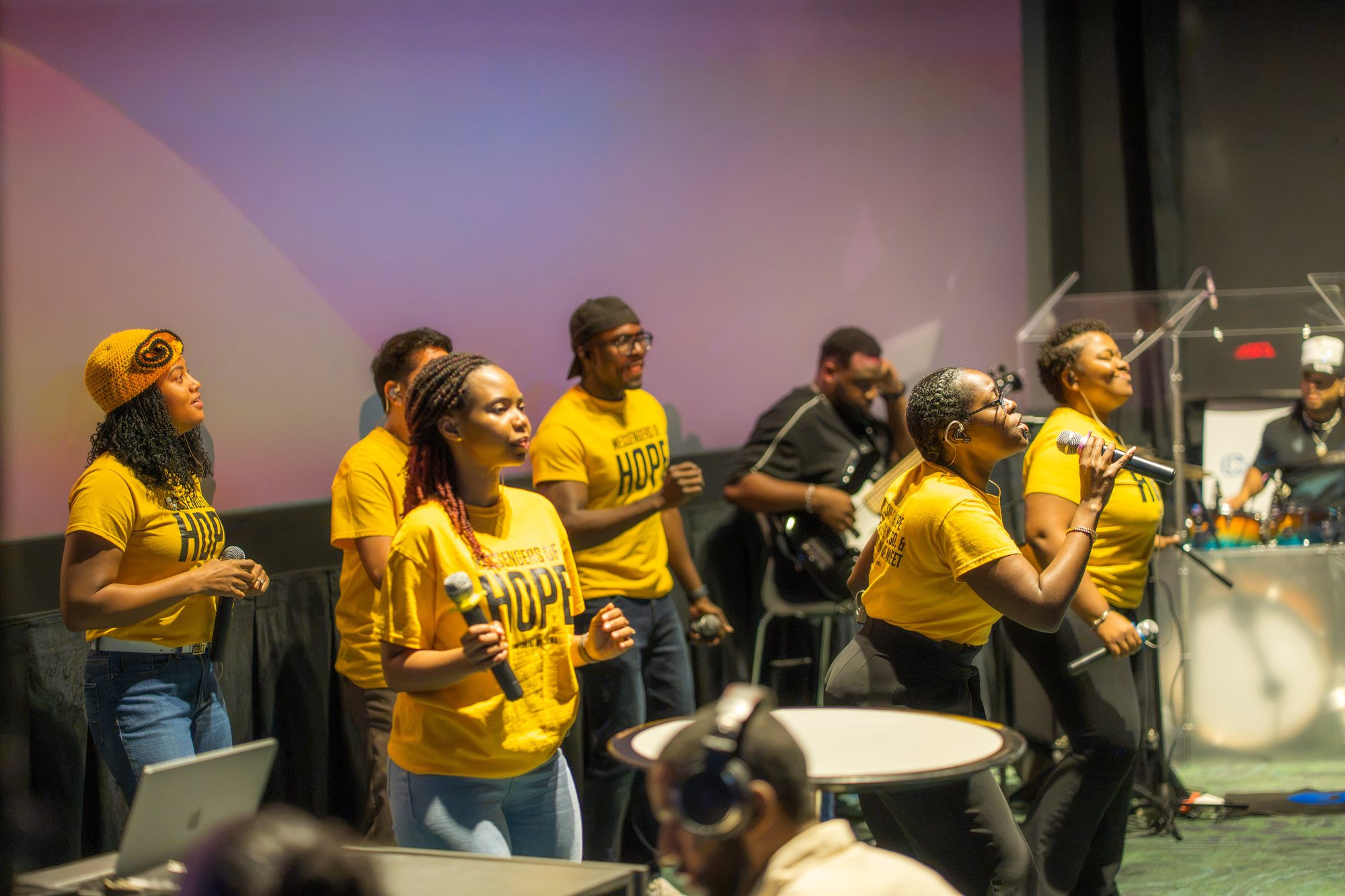 CIAG's worship team sings in yellow Messengers of Hope shirts.