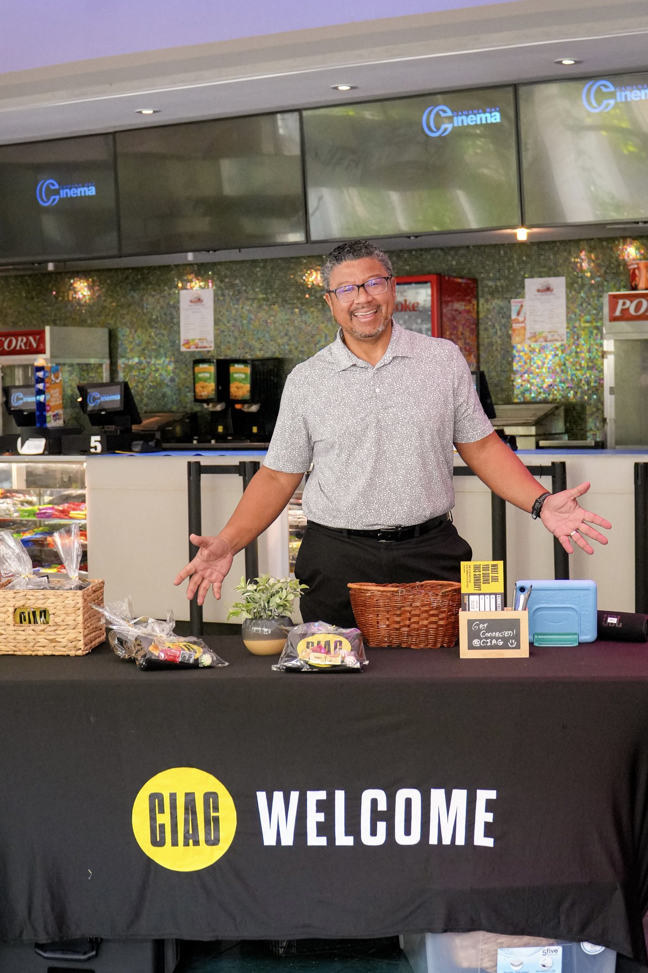 A volunteer welcomes people at the CIAG welcome desk.