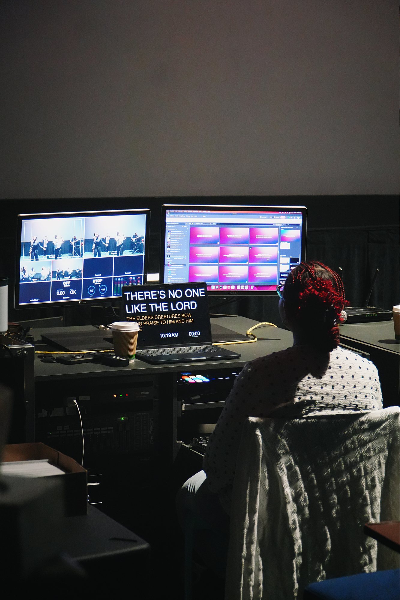A volunteer operates the production screens during worship.