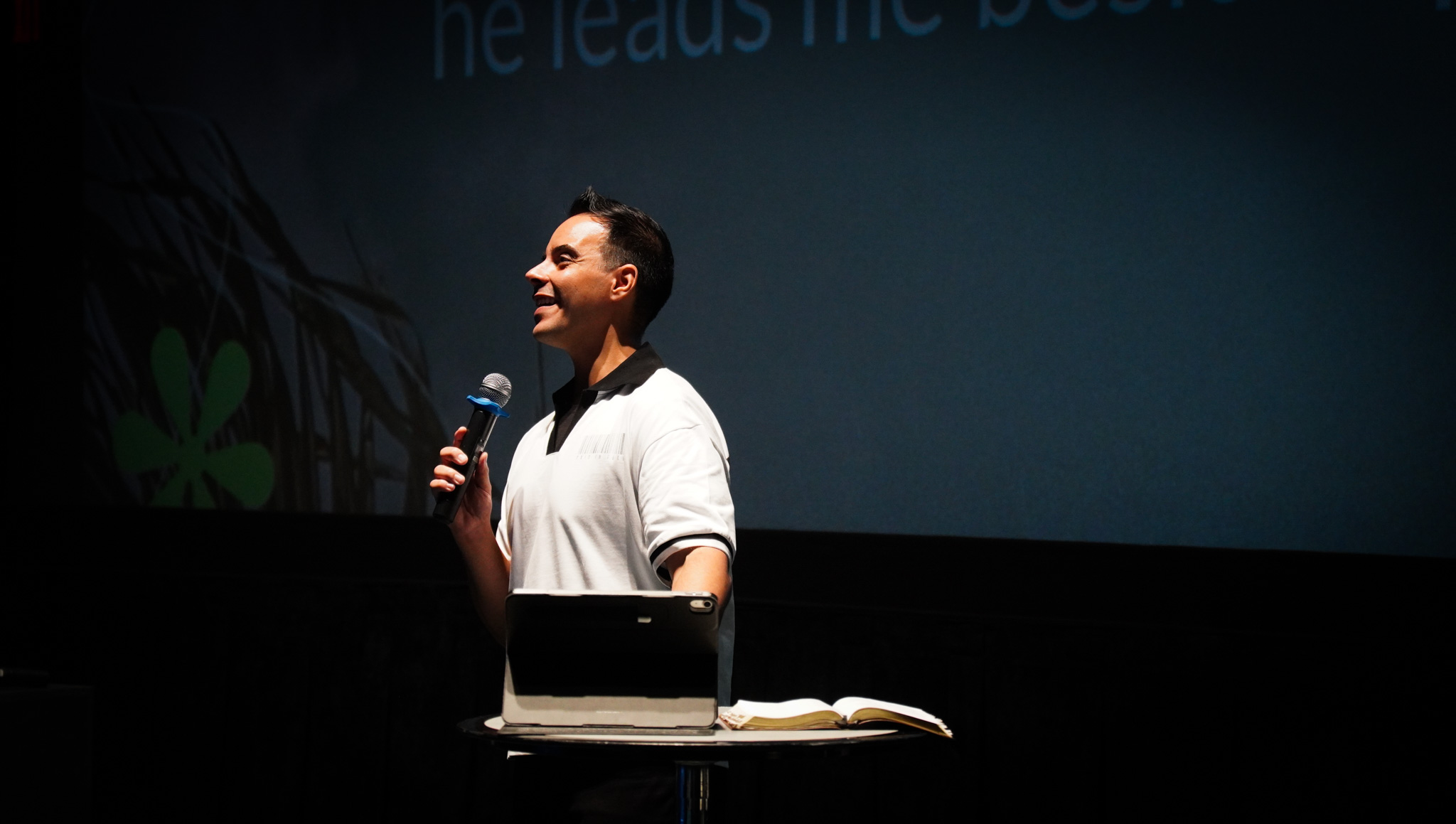 A speaker teaches with an open Bible during a CIAG Sunday service.