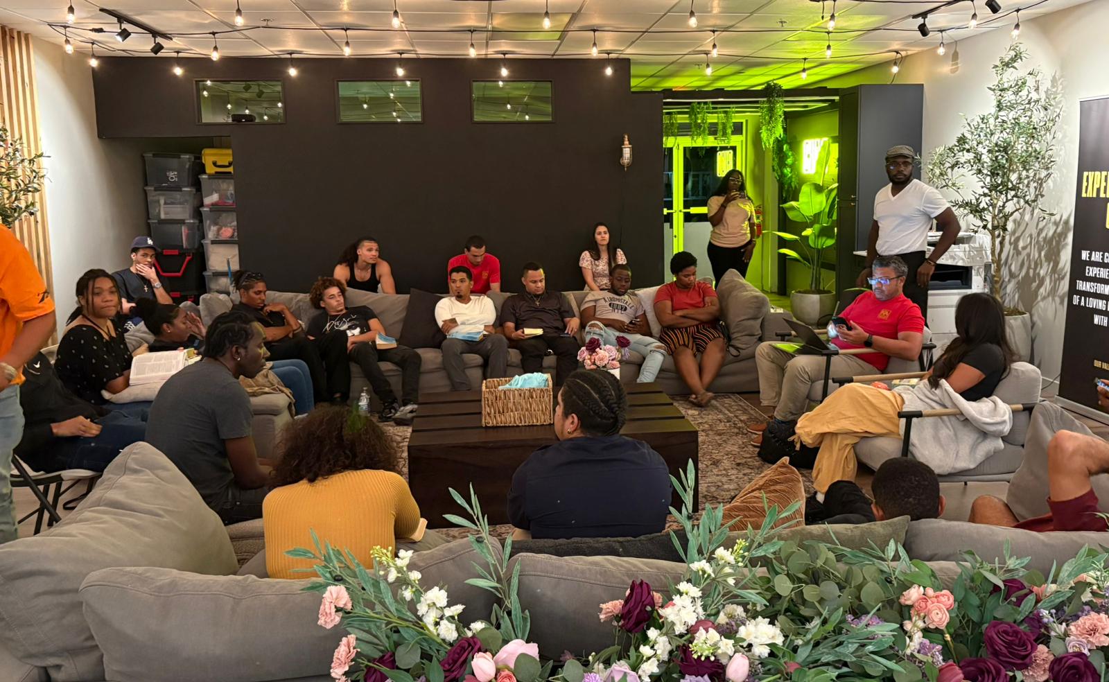 An RNB group sits together around sofas in the CIAG office lounge.
