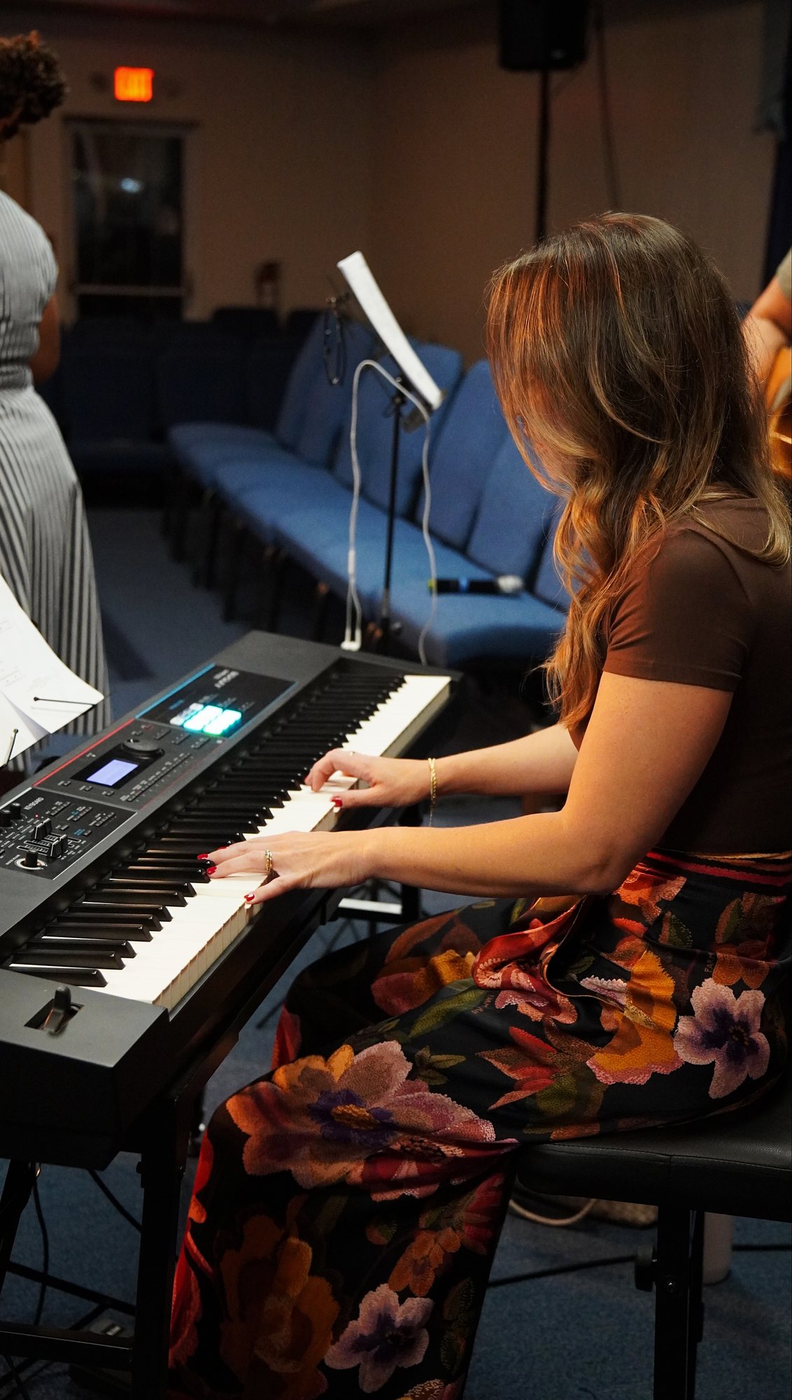 A musician plays a keyboard during a church gathering.