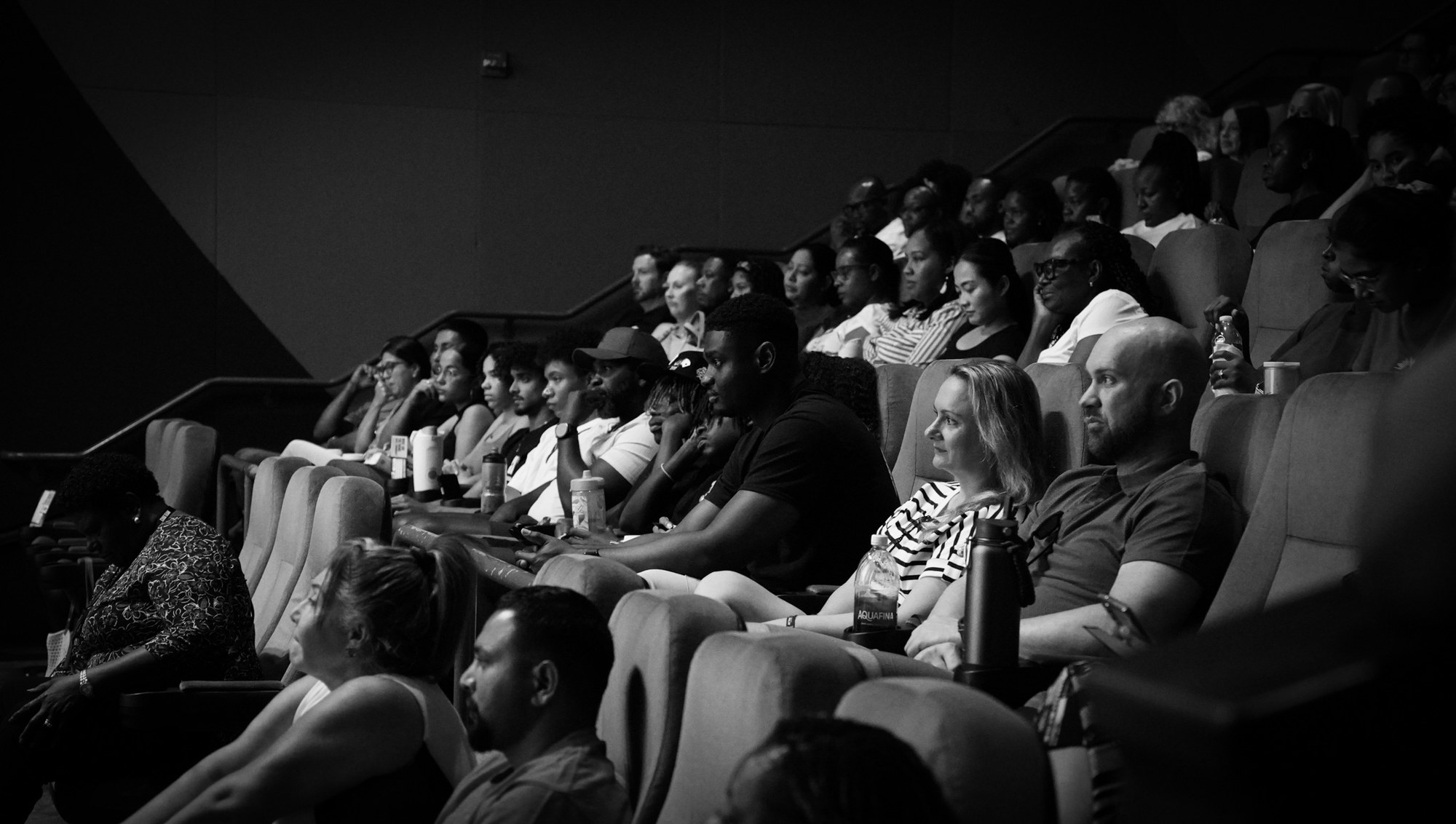 People sit together in the auditorium during a service.