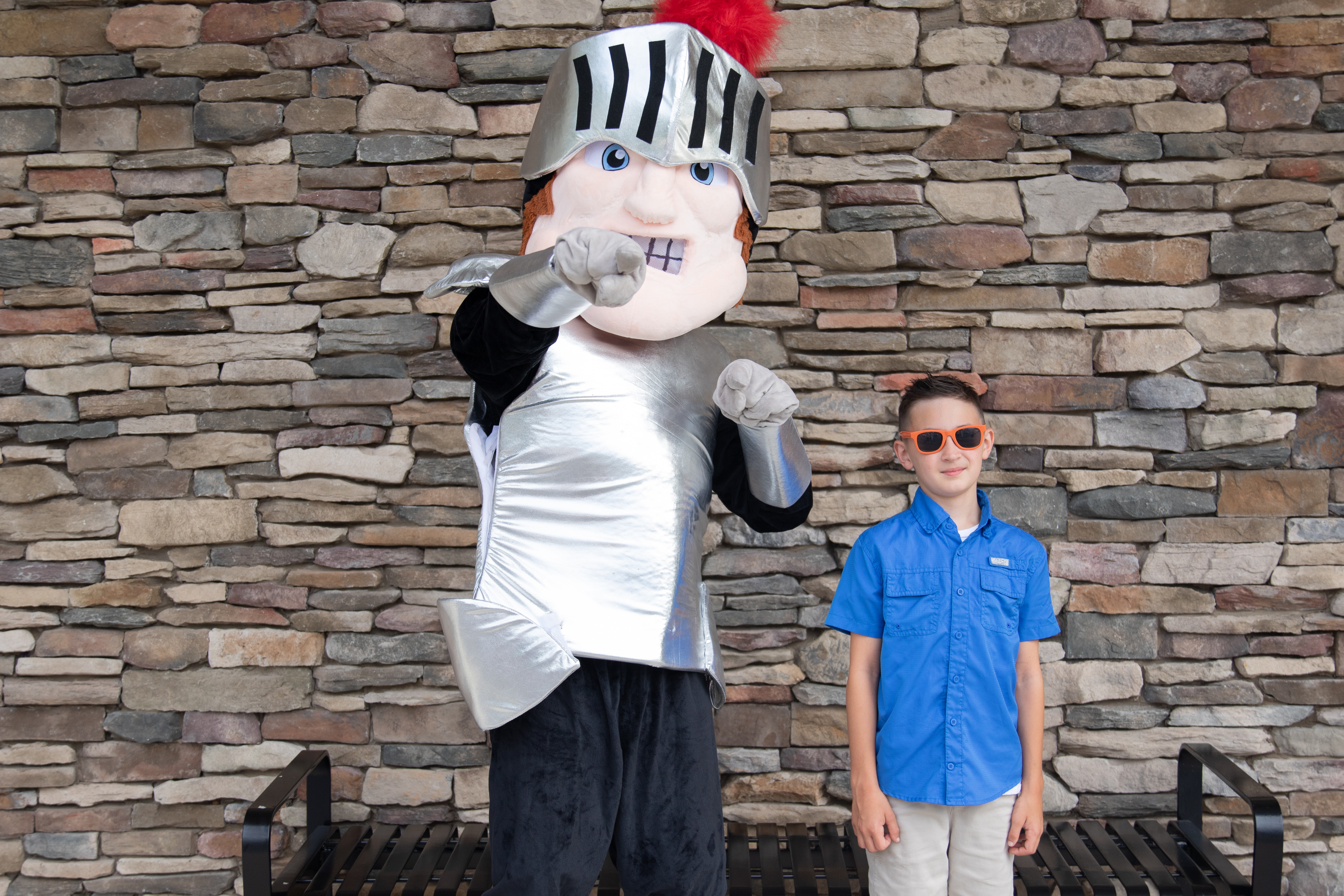 Theo the mascot with students at Lighthouse Baptist Academy