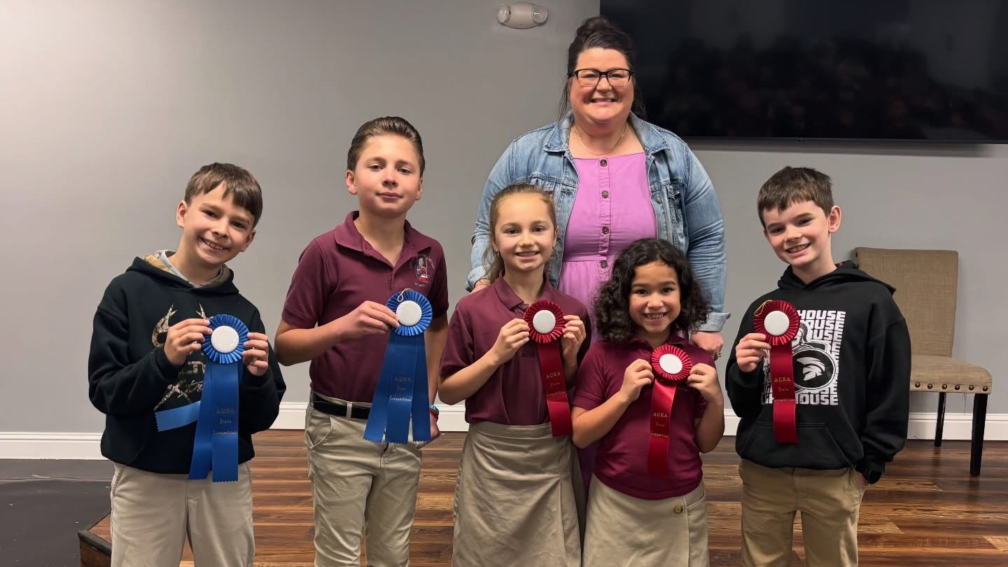 Elementary students receiving awards after district academic competitions at Lighthouse Baptist Academy