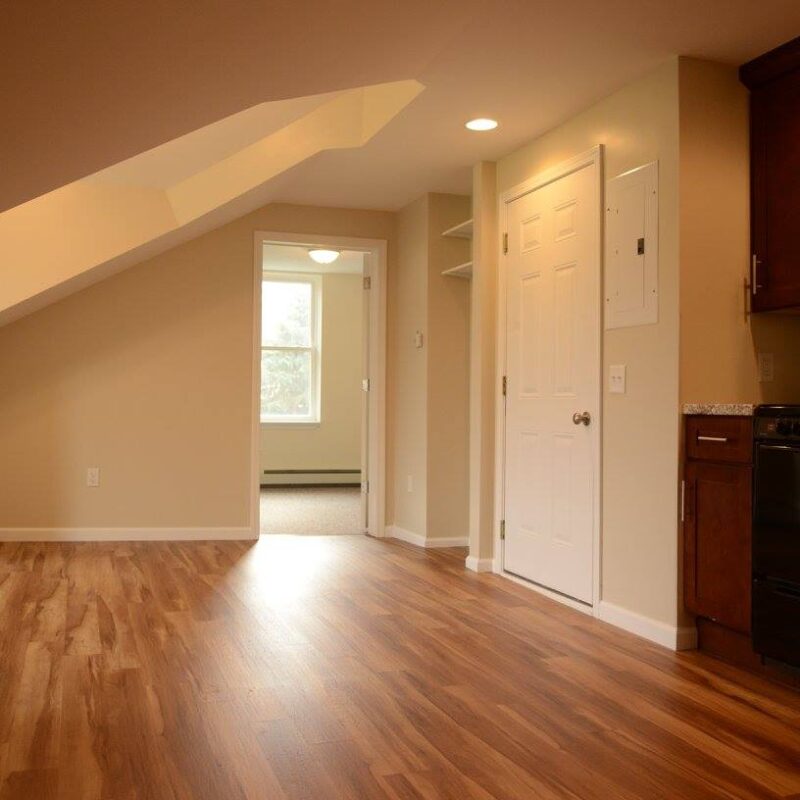 Front door and bedroom in the distance