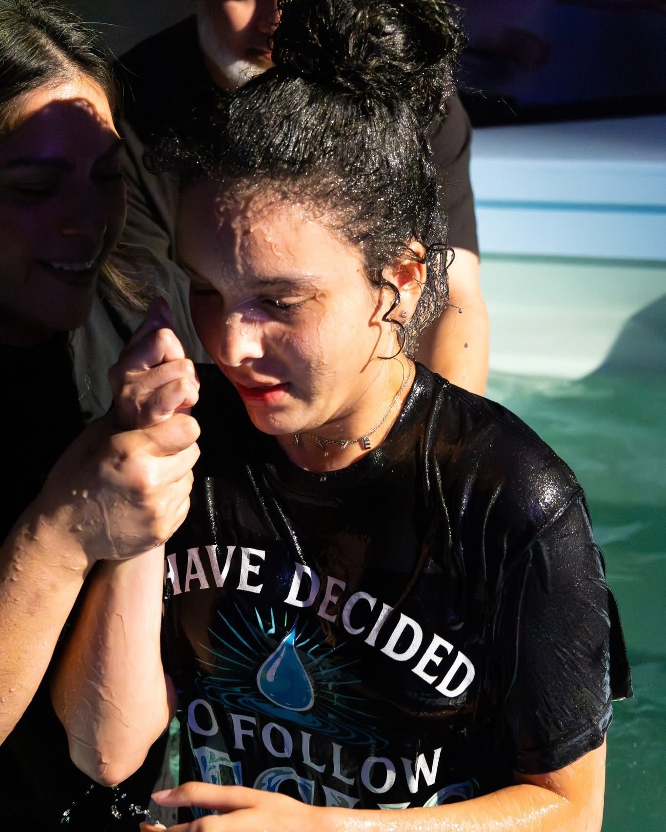 A teenage girl in an 'I have decided to follow Jesus' shirt, just baptized