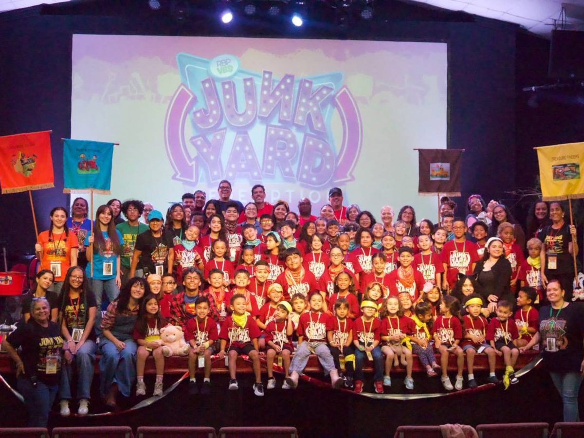 Sinai Kids and their leaders gathered on stage in red shirts at Vacation Bible School