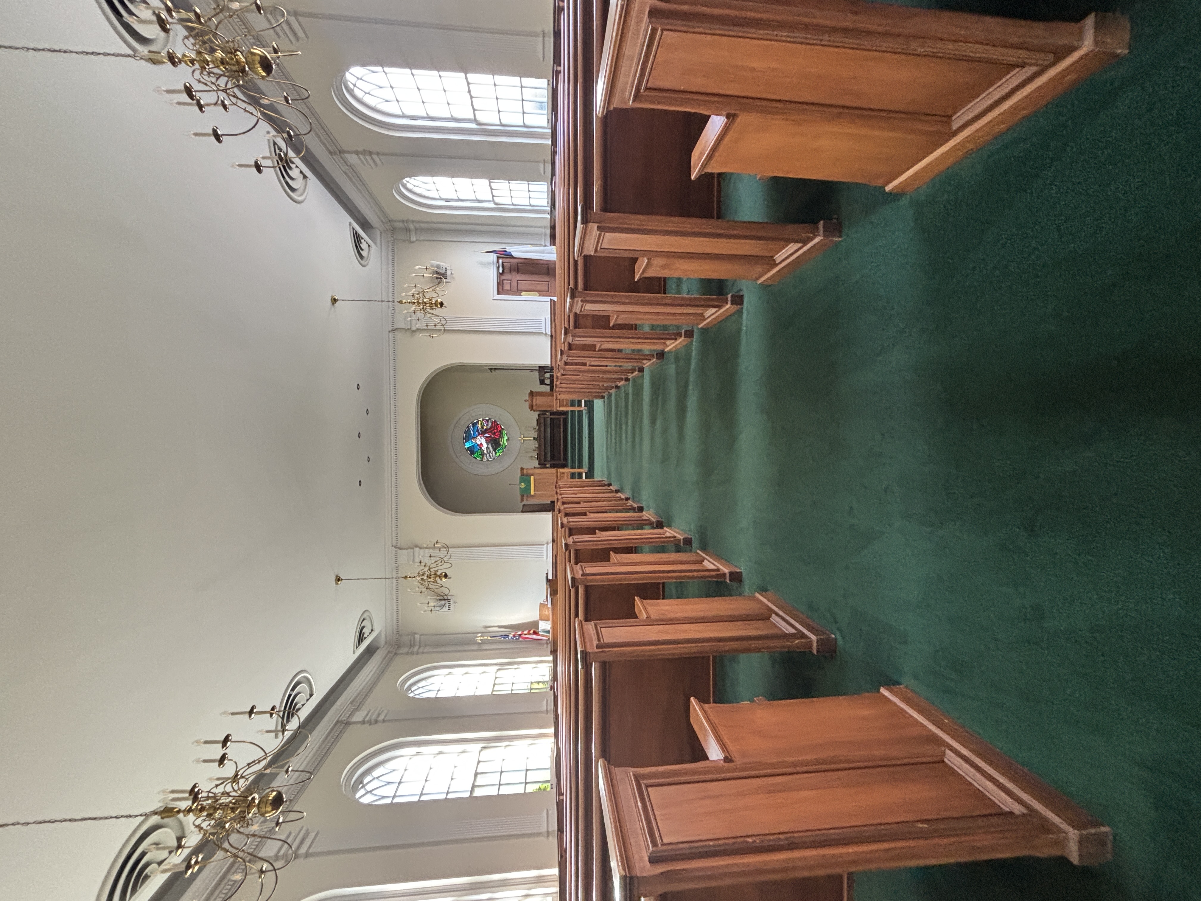 Worshipers standing in the pews during a hymn in the chapel.