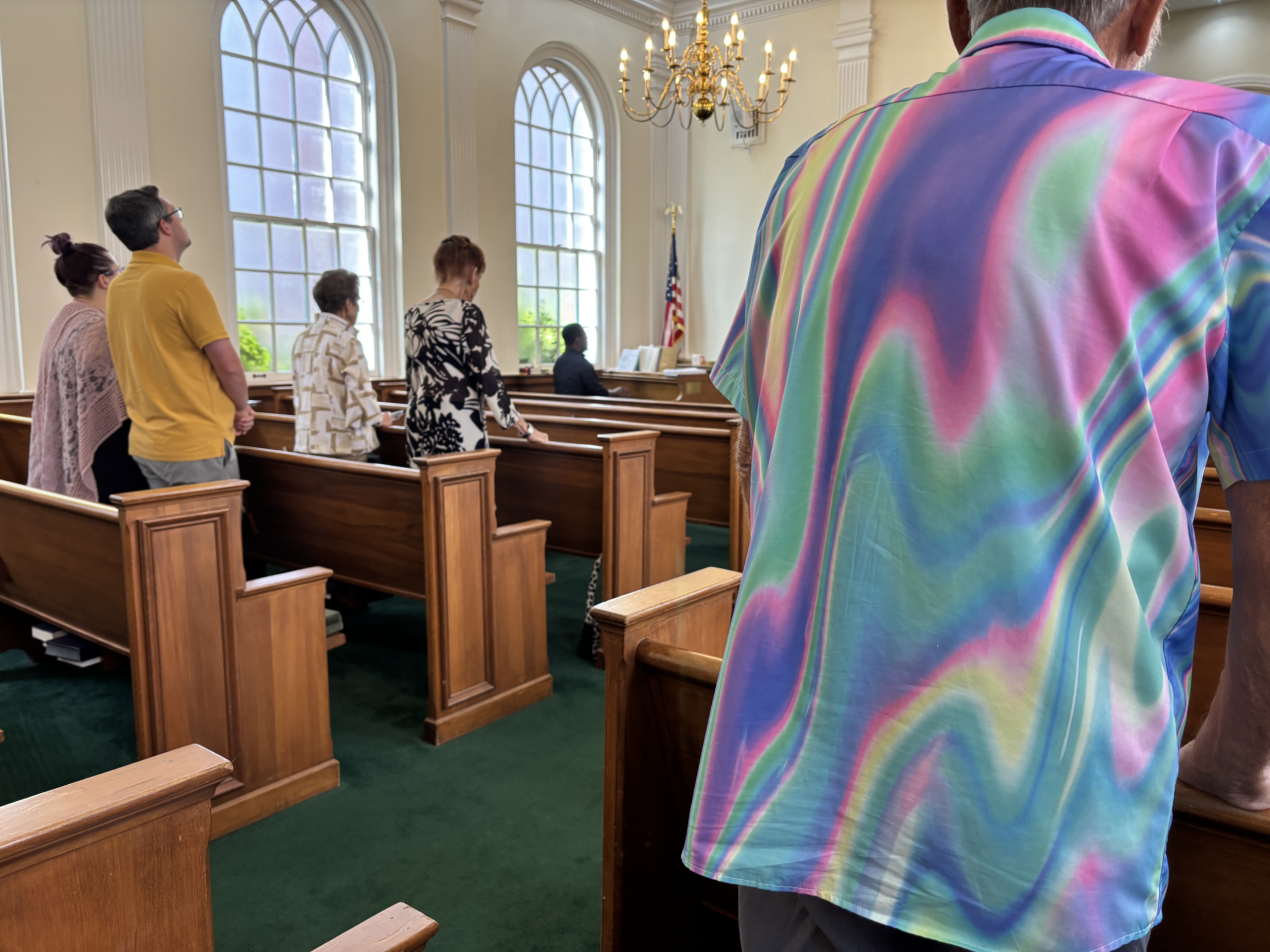 The congregation standing together during worship in Acker Chapel.