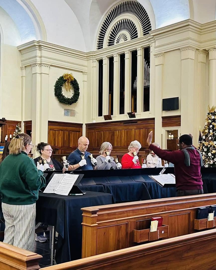 The handbell choir playing during worship.