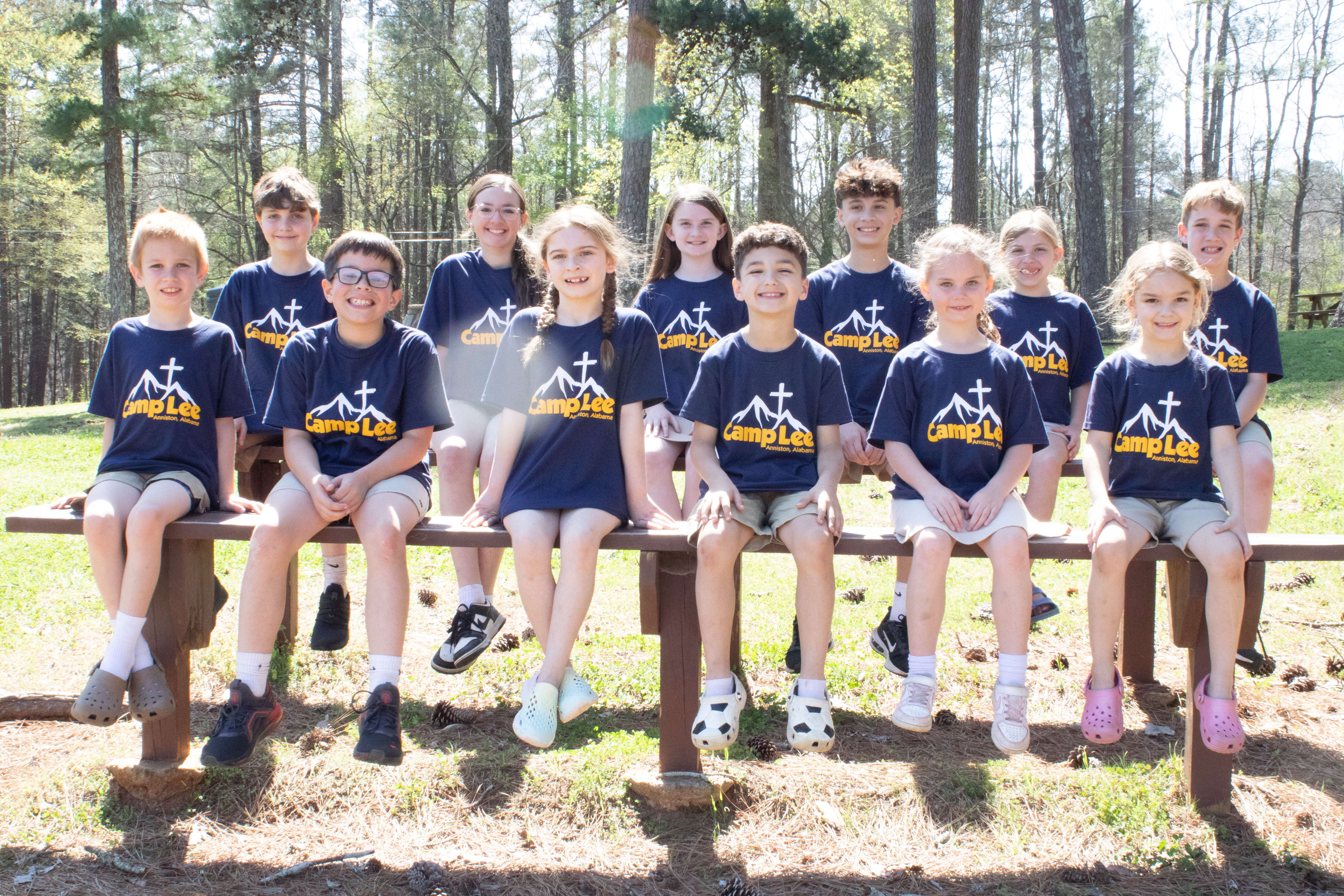 A group of day campers in Camp Lee shirts posing together outdoors