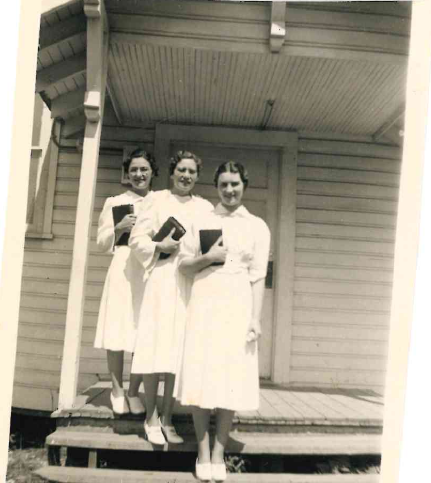 Mary Carnes, Vava Walker, and Doris Hanson standing at the entrance of the Ignite church in 1940